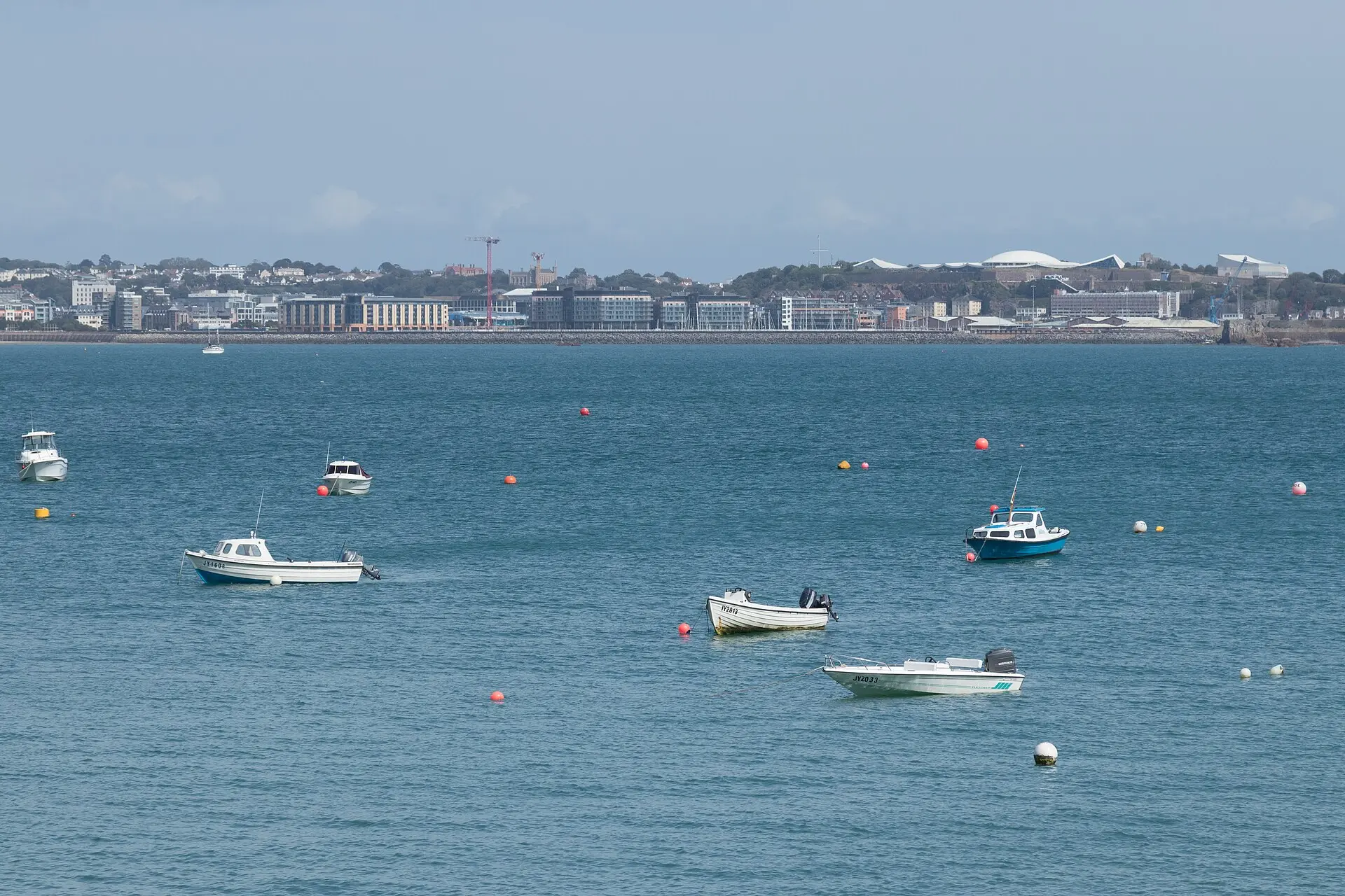 Boats moored in St Aubin's Bay with St Helier behind