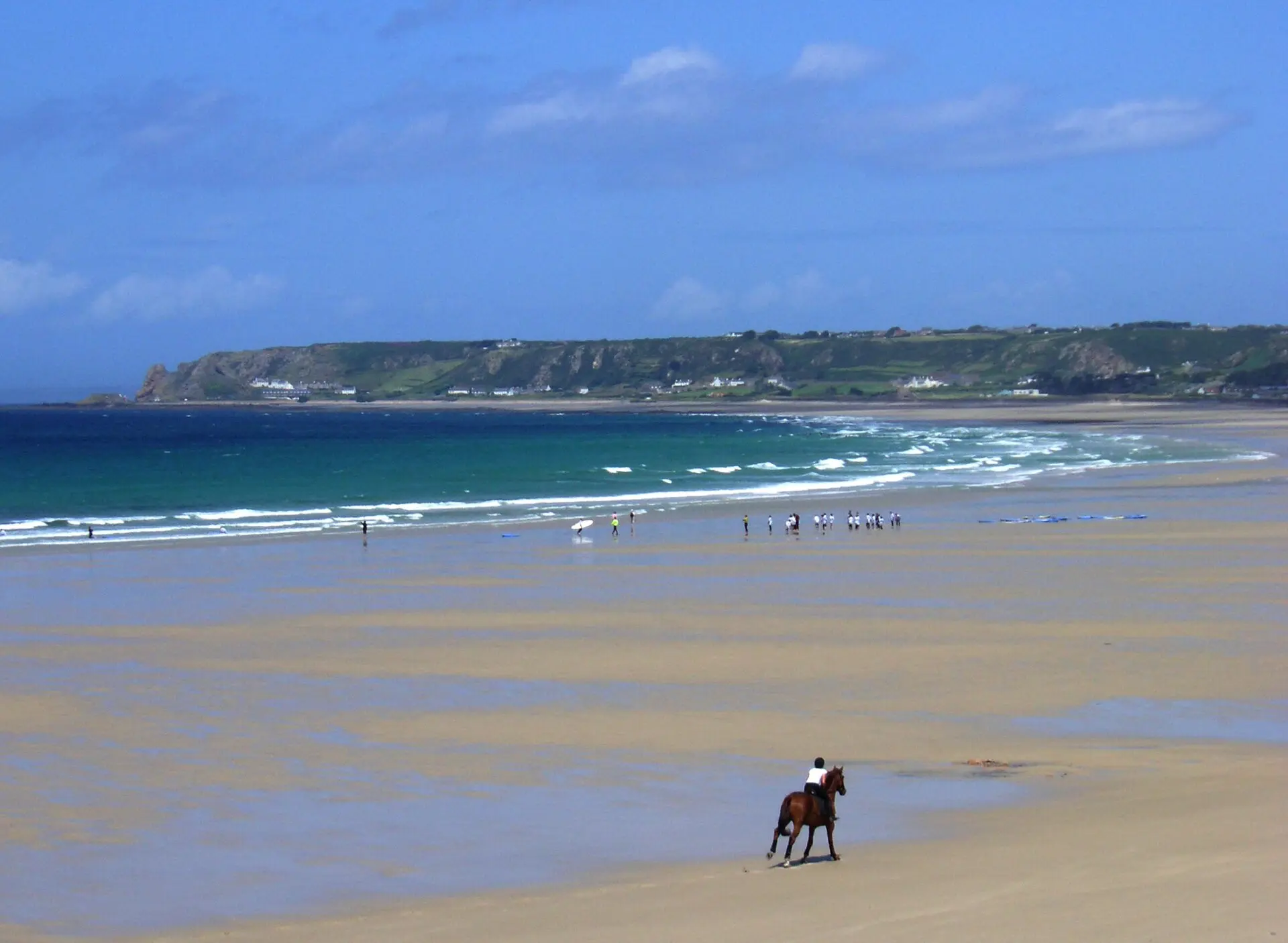 Horse rider on the wide sands of St Ouen's Bay